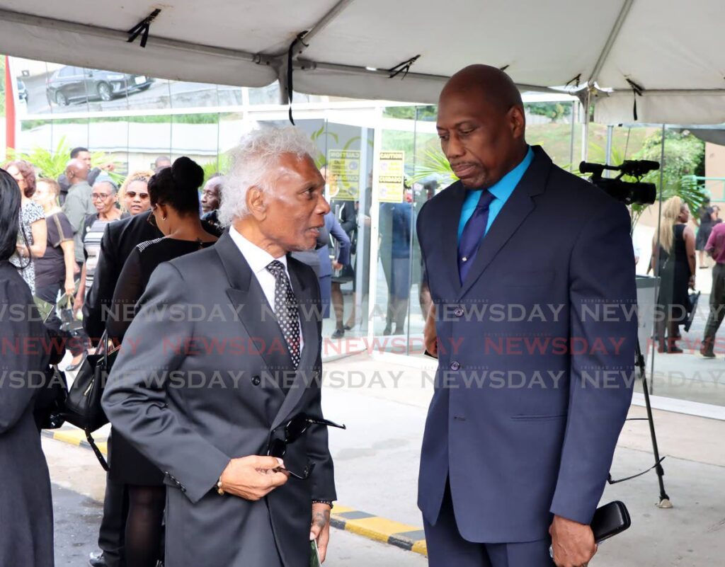 Head of the Criminal Bar Association Israel Khan, SC, left, and Director of Public Prosecutions (DPP) Roger Gaspard, SC speak during the funeral for attorney Randall Hector at the University of the Southern Caribbean, Maracas, St Joseph, on January 9. - Photo by Ayanna Kinsale