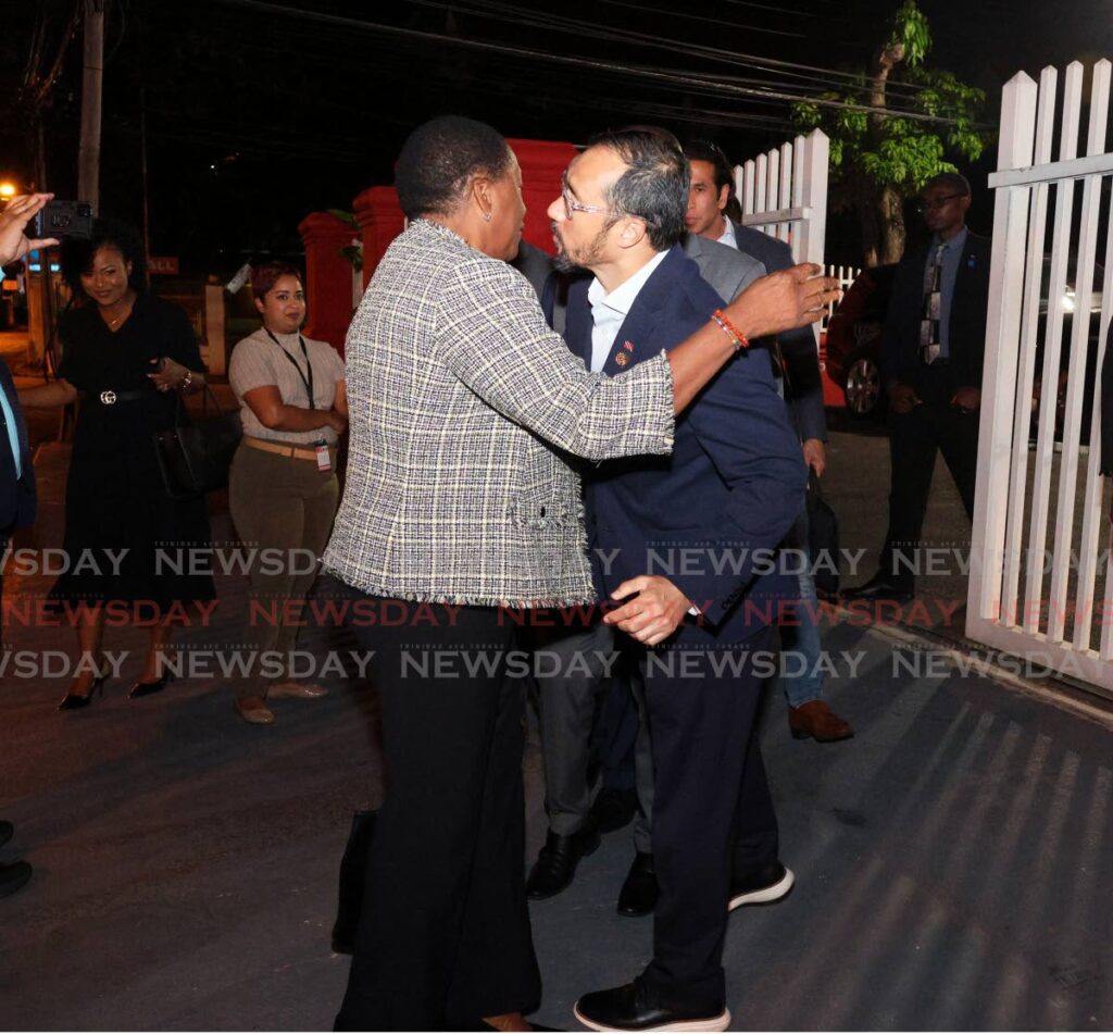 Minister of Planning and Development Penelope Beckles and Minister or Energy and Energy Industries Stuart Young hug each other after a PNM central executive meeting at Balisier House, Melville Lane,
Port of Spain on January 9.
 - Faith Ayoung