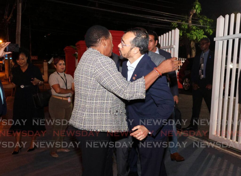 Minister of Planning and Development Penelope Beckles and Minister or Energy and Energy Industries Stuart Young hug each other after a PNM central executive meeting at Balisier House, Melville Lane,
Port of Spain on January 9. - Photo by Faith Ayoung