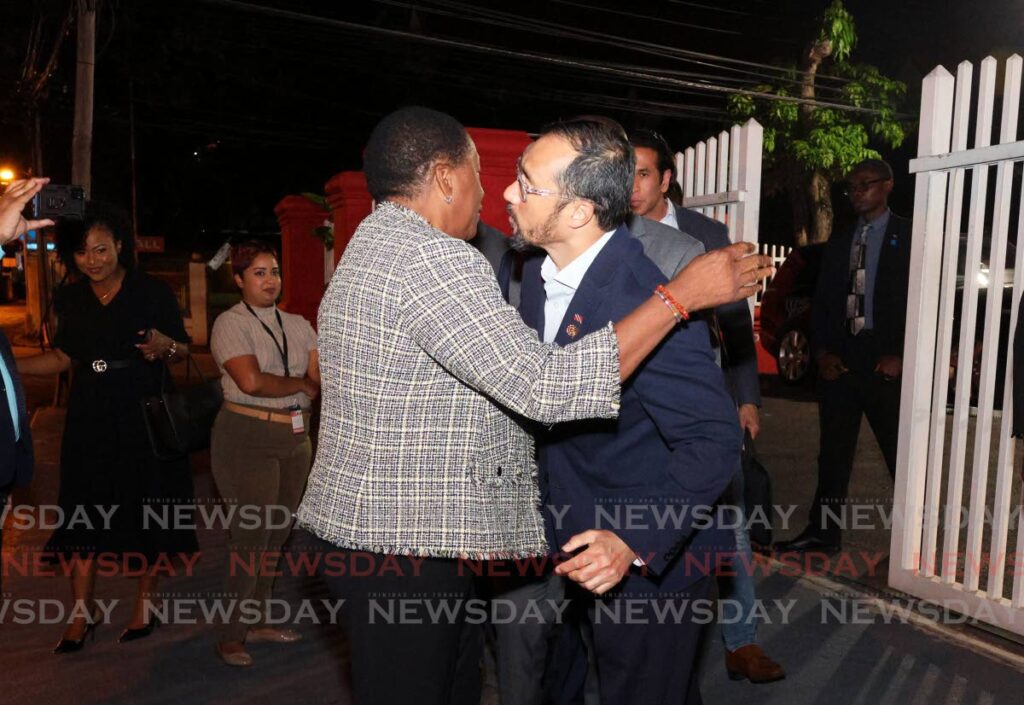 FRIENDS CLOSE...: Minister of Planning and Development Penelope Beckles and Minister or Energy and Energy Industries Stuart Young hug eachother after a PNM central executive meeting at Balisier House, Melville Lane, Port of Spain on January 9. - Photo by Faith Ayoung