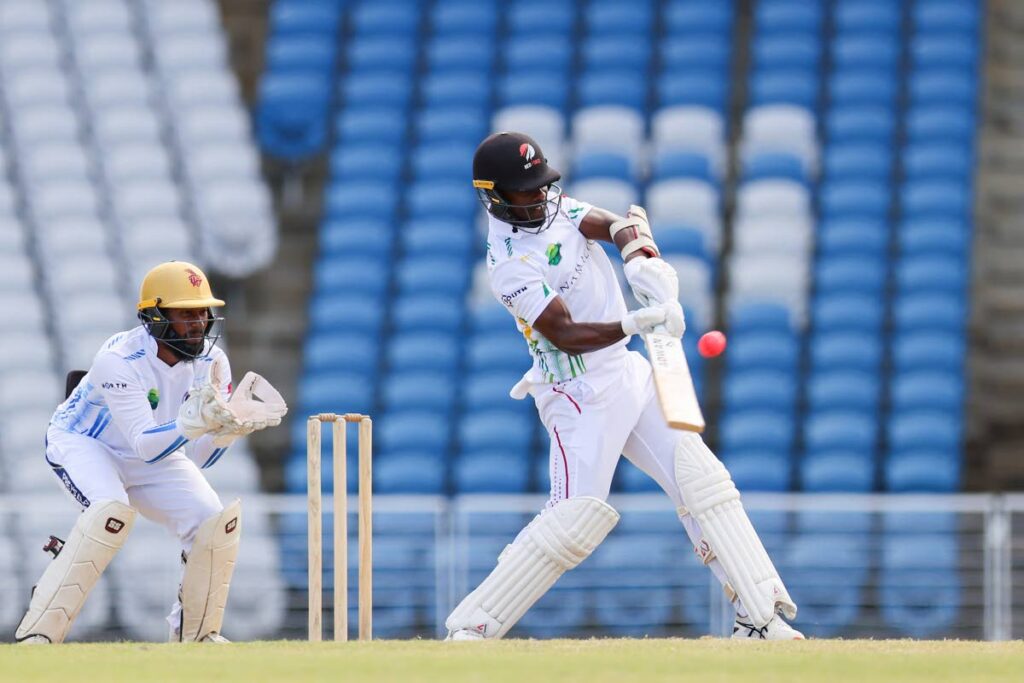 South batsman Jason Mohammed plays a pull shot for six while North wicketkeeper Antonio Gomez looks on during day three of the Namalco/TTCB Senior North South Classic at the Brian Lara Cricket Academy on January 11, 2024 in Tarouba, Trinidad. - Photo by Daniel Prentice 