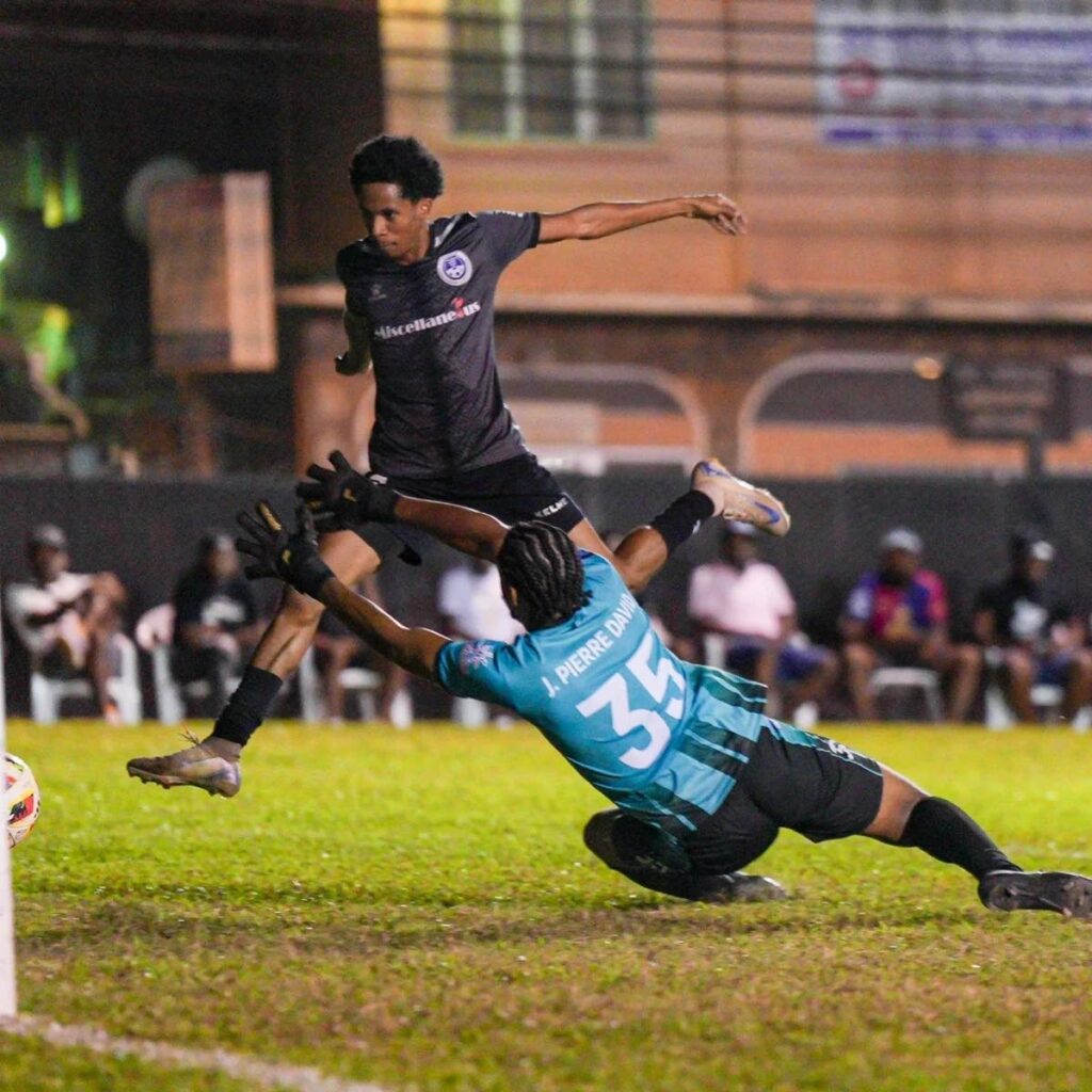 Miscellaneous Police FC attacker Jordan Riley shoots past Eagles FC custodian Jon-Pierre David in their TT Premier Football League match at St James Police Barracks on January 11. - Photo courtesy TTPFL