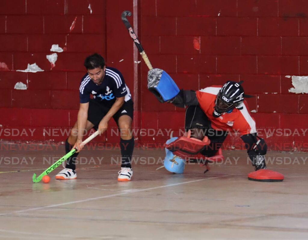 Queens Park Cricket Club's Rob Wyatt tries to score past Trinidad and Tobago Police Service goalkeeper Kevin Joseph during the Ventures Invitational Indoor Tournament at the Woodbrook Youth Facility, Port of Spain, January 12. - Photo by Ayanna Kinsale