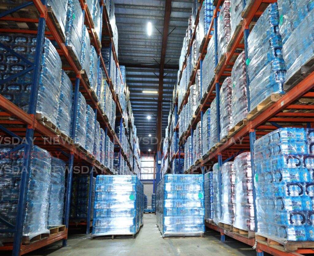 Crates of Blue Waters products stacked on shelves at the company's manufacturing facility in Orange Grove Road, Tacarigua on January 13. - Photos by Faith Ayoung