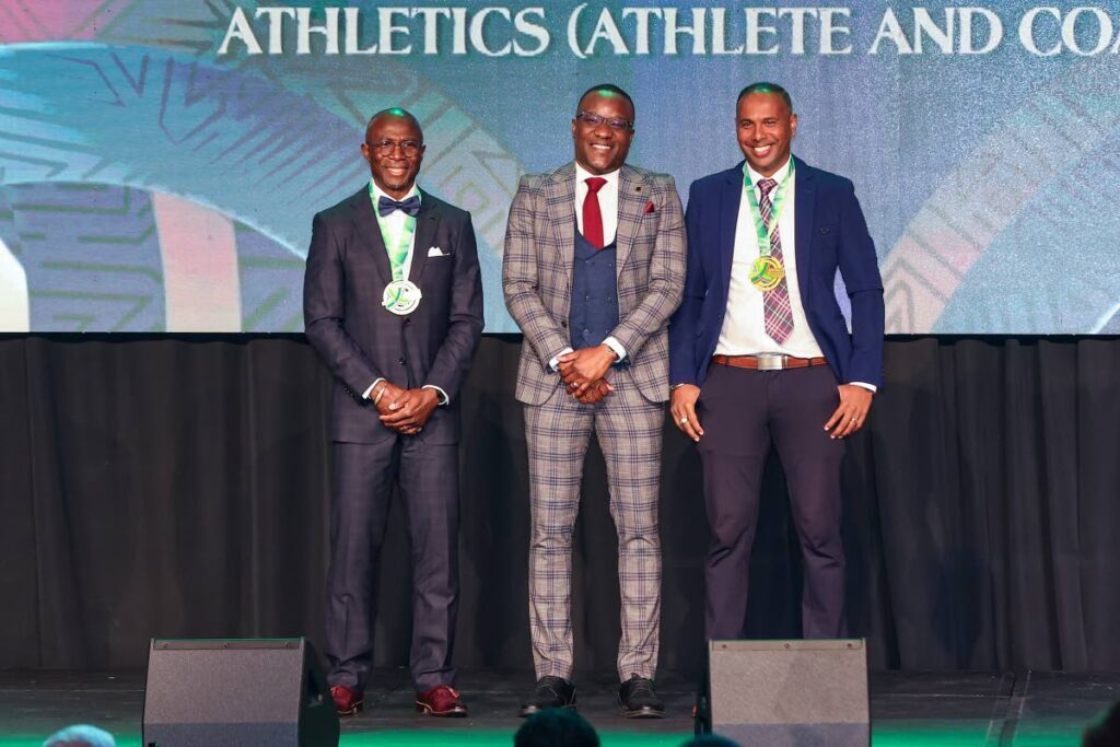 First Citizens Sports Foundation 2025 Hall of Fame awardees forner national and West Indies cricketer Samuel Badree (R) and former TT long jumper Wendell Williams (L) stand alongside acting Ministry of Sport and Community Development permenant secretary David Roberts during the awards ceremony, on January 11, 2025 at the Hyatt Regency, Port of Spain.  - Photo by Daniel Prentice 