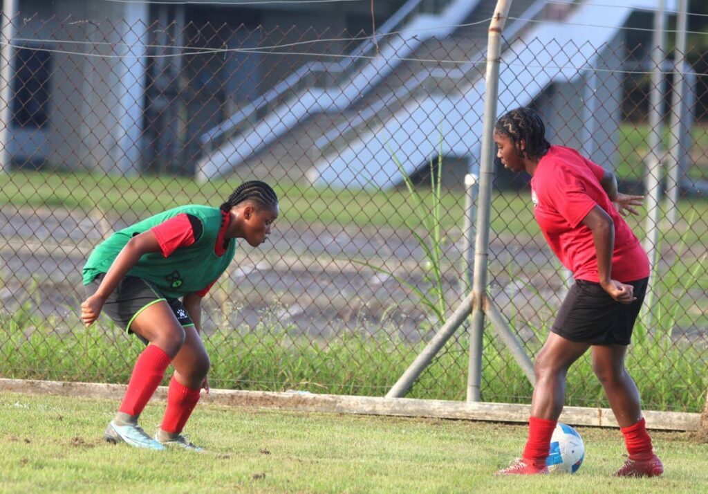 Eyes on the prize: TT under-17 women’s team playmaker Orielle Martin (right) takes on a teammate during a training session on January 10. - Photo courtesy TTFA media.   