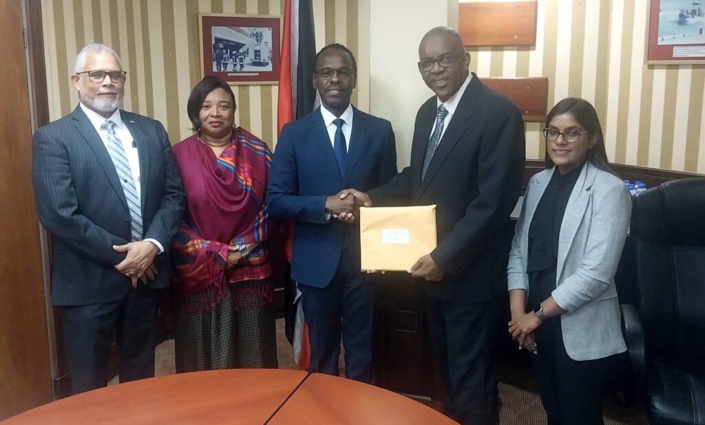 National Security Minister Fitzgerald Hinds, centre, and Sandra Fraser, Permanent Secretary, Ministry of National Security, second left, were on hand to receive the final report of the committee appointed to investigate the response of the Trinidad and Tobago Fire Service, to the December 16 fire at No. 11 Farfan Street, Arima, at ministry in Port of Spain on January 10. Minister in the Ministry of Education Lisa Morris-Julian and two of her children died in the fire. From left, are committe members health, safety, security and Environment (HSSE) specialist Curt Cadet, former chief fire officer Roosevelt Bruce and attorney-at-law, Office of the Attorney General Ashtee Mahabir. - Photo courtesy Ministry of National Security