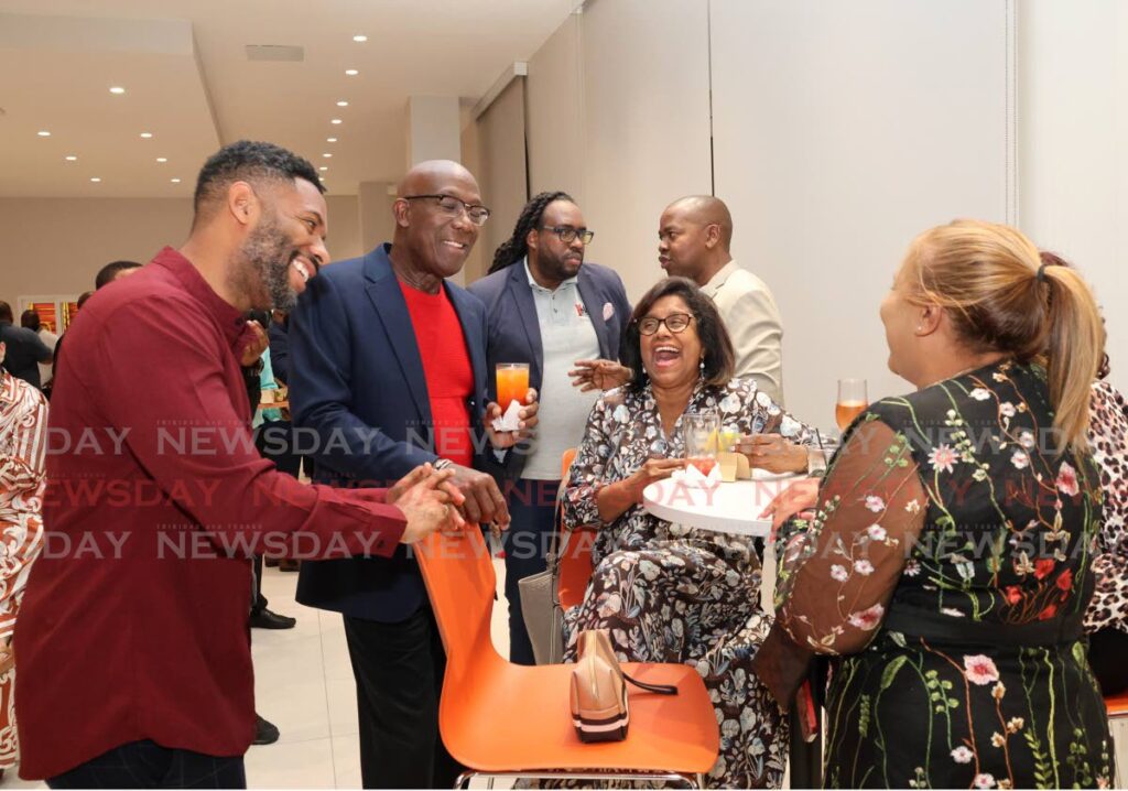 From left, Hans Des Vignes, television personality and radio broadcaster, Dr Keith Rowley and Paula Gopee-Scoon, Minister of Trade and Industry, enjoy themselves at the PNM's annual Media Mix and Mingle at Balisier House, Tranquillity Street, Port of Spain on January 15. - Photo by Faith Ayoung