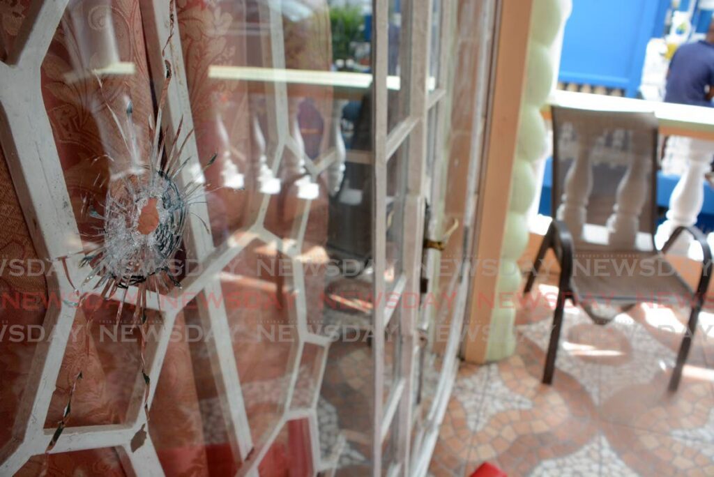 A bullet hole remains in the glass door of a Princes Town home after bandits shot at it after a botched home invasion on January 15. - Photo by Innis Francis