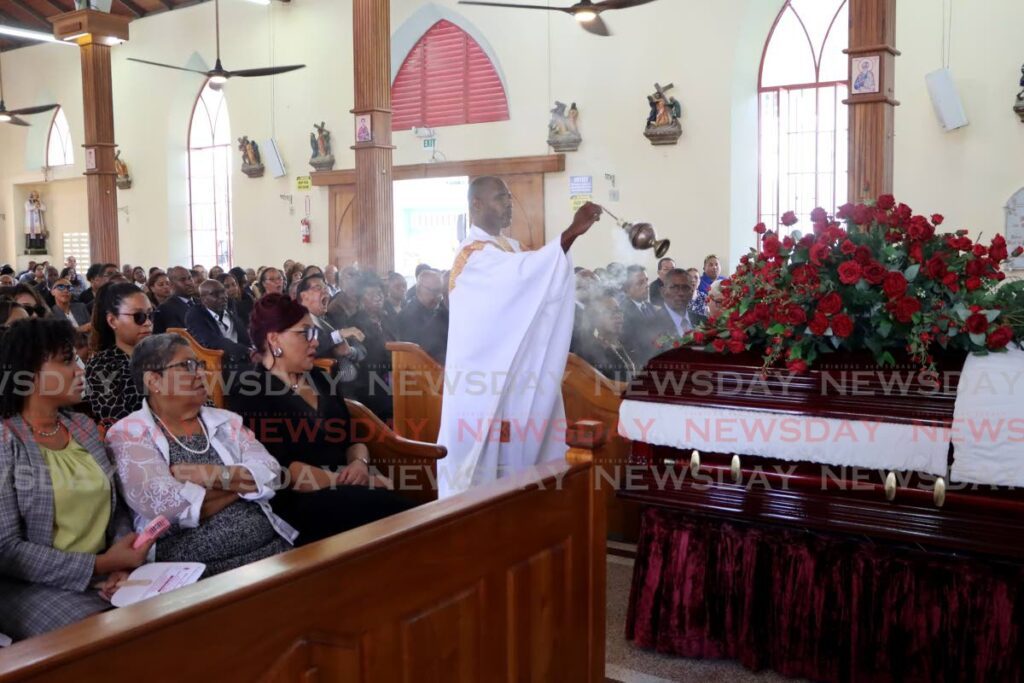 In this file photo, Fr Maurice White performs the final rites at the funeral service of former Newsday consultant Jones P Maderia at the Santa Rosa RC Church, Arima on January 16. - Photo by Ayanna Kinsale