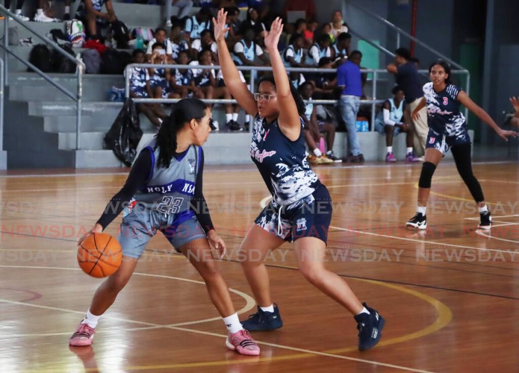 Holy Name Convent Ashaki Charles dribbles against Fyzabad Anglican Secondary School Ashlee Seepaul during the TT Schools Basketball Association's North-Zone league game at the Maloney Indoor Courts, on January 16, 2025. - Photos by Ayanna Kinsale