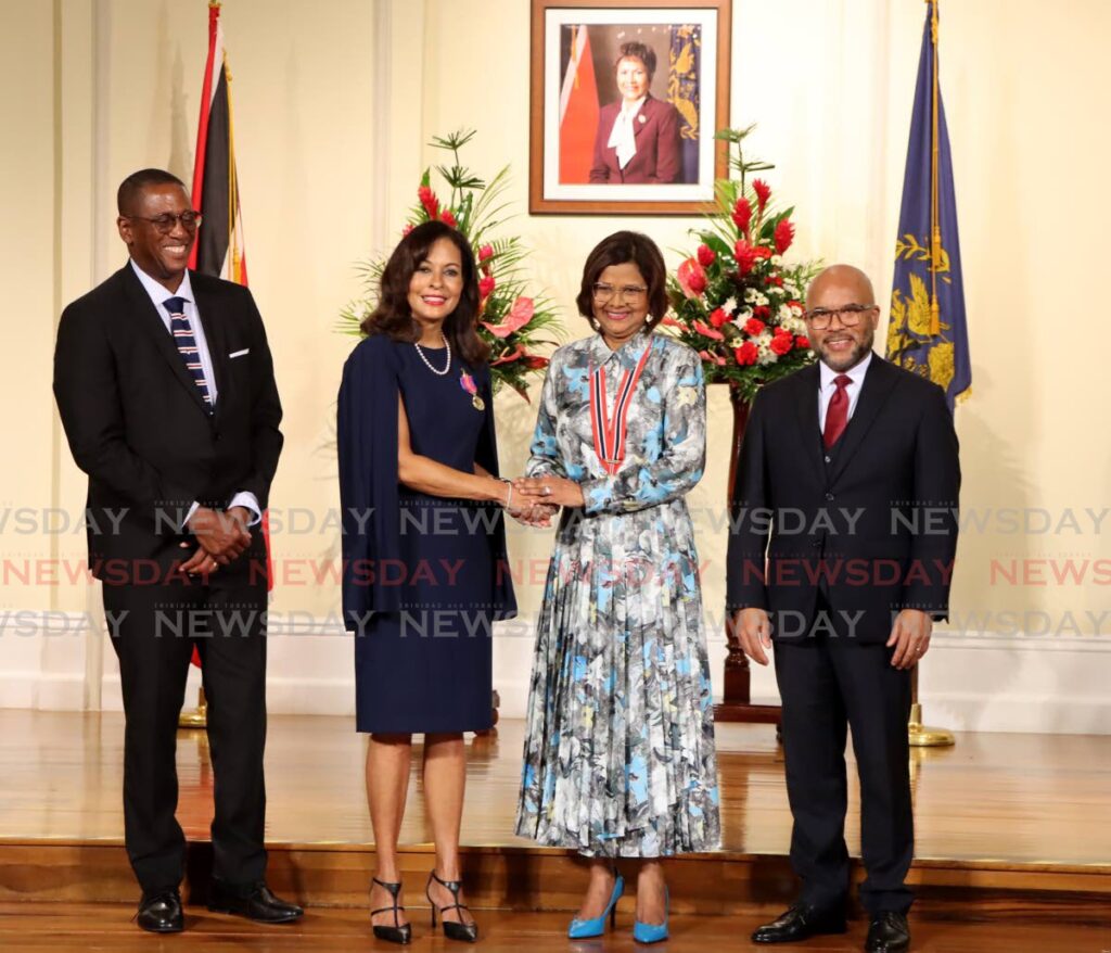 President Christine Kangaloo congratulates outgoing US Ambassador Candace Bond after she received the Hummingbird Gold medal at President's House, St Ann's, Port of Spain, on January 17. Looking on are Chief Justice Ivor Archie, left, and the President's husband Kerwyn Garcia, SC. - Photos by Ayanna Kinsale