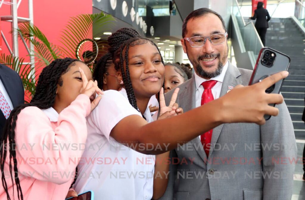 Energy Minister Stuart Young takes a selfie with Woodbrook Secondary School syudents during the Navigating Growth and Opportunities Expo at NAPA, Port of Spain, on January 17. - Photos by Ayanna Kinsale