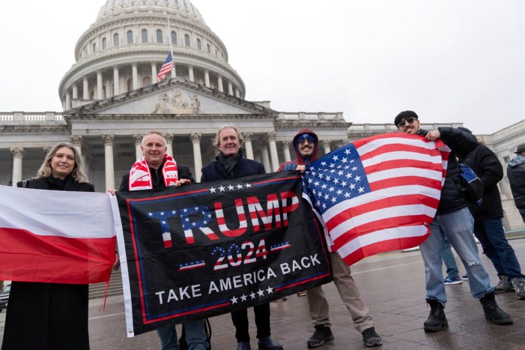 Supporters of President-elect Donald Trump take pictures as they celebrate outside of the US Capitol, Sunday, in Washington.  - AP