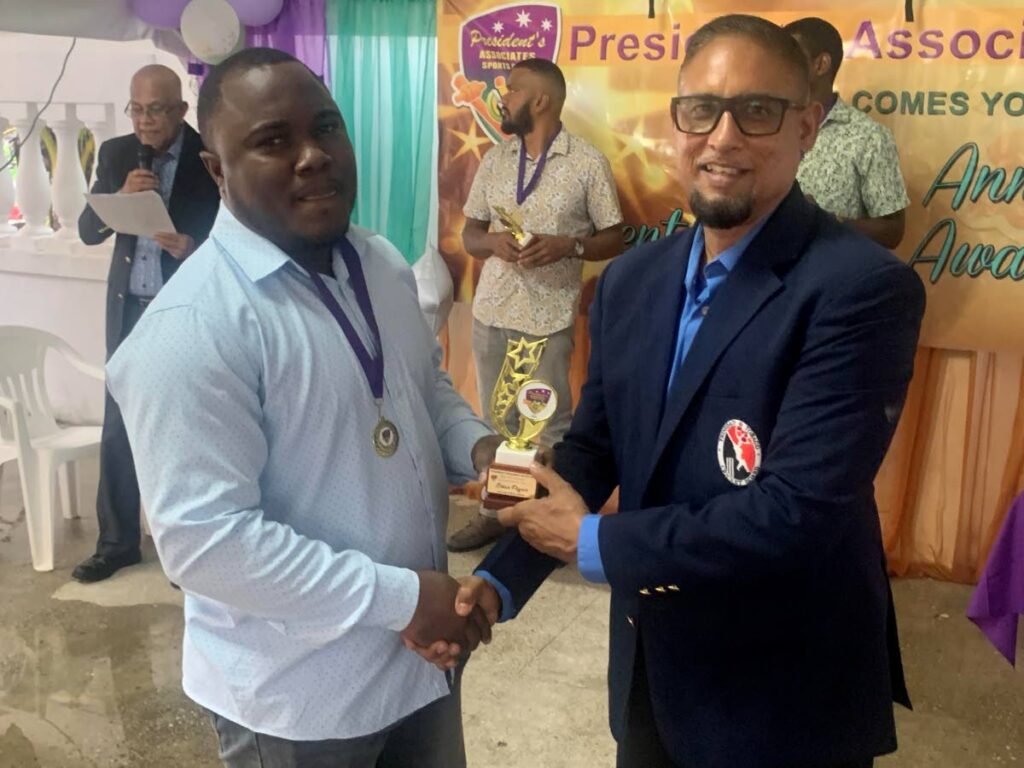 President's Associates Cricketer of the Year Brian Pegues receives one of his many awards from TT Cricket Board secretary Altaf Baksh at the club's awards in St Mary's on January 18, 2025. - 