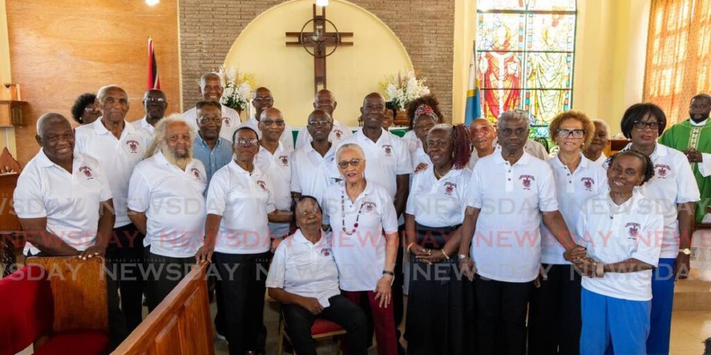 The Prime Minister, centre, with graduates from the Bishop's High School class of 1966 at a thanksgiving service at the St Patrick's Anglican Church, Mt Pleasant, Tobago, on January 19. - 