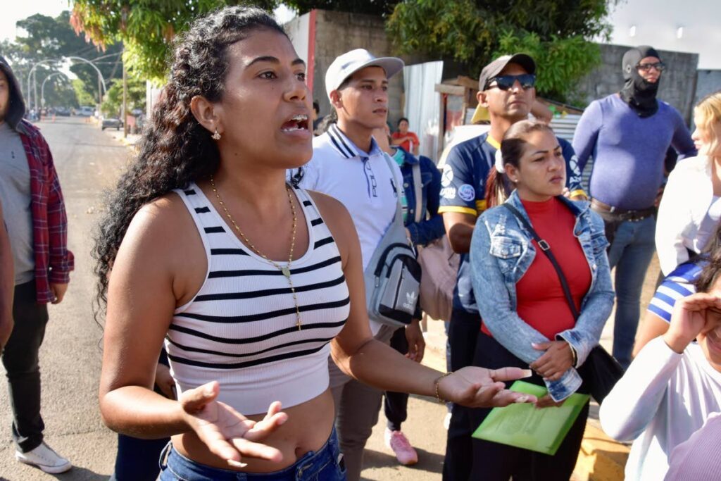 Venezuelan migrant Oriana Mateus appeals to a Mexican migration officer who has told her that permission for migrants to travel across Mexico to the US border was suspended after the US Customs and Border Protection announced the CBP One app would no longer be used to admit migrants, in Tapachula, Mexico, on January 21.  - AP Photo