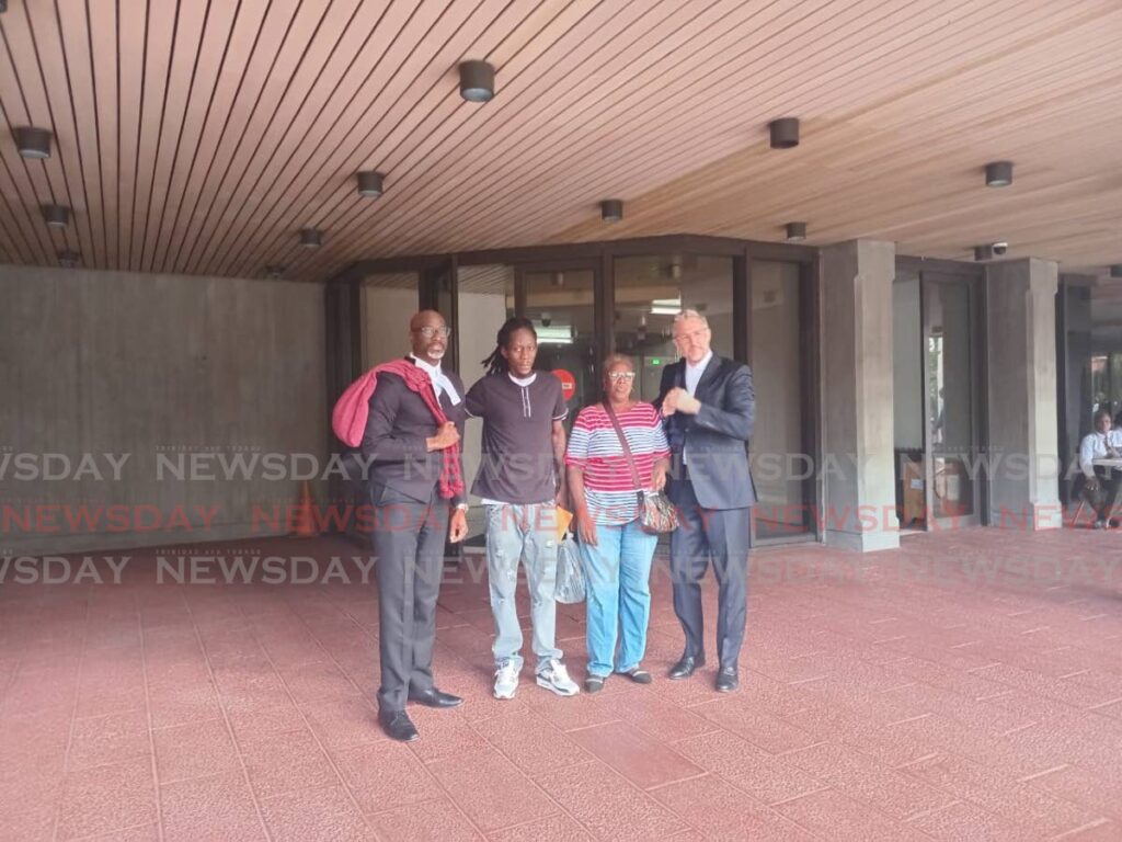 FREED: Kareem Halls, second from left, with his mother Carol and attorneys Kelston Pope, left, and Dr Jens-Ulrich Poppen at the Hall of Justice, Port of Spain, on January 22. - Photo by Jada Loutoo