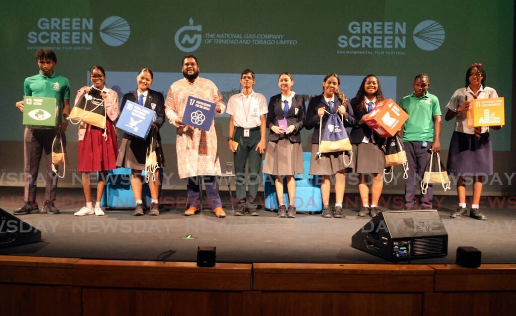 Lawrence Arjoon, CEO of The Heroes Foundation, fourth from left, stands with students who won tokens for a quiz at the Green Screen School Screenings and Green career Talks at Queen's Hall, St Ann's, on January 23. - Photo by Faith Ayoung