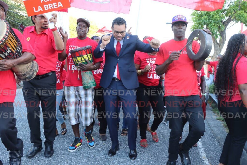 VICTORY DANCE: Tourism Minister Randall Mitchell dances with supporters as he made his way to Balisier House on Thursday to be screened. Hours later, he danced out of Balisier House after getting the nod to be the candidate for La Brea.  - Photo by Ayanna Kinsale 