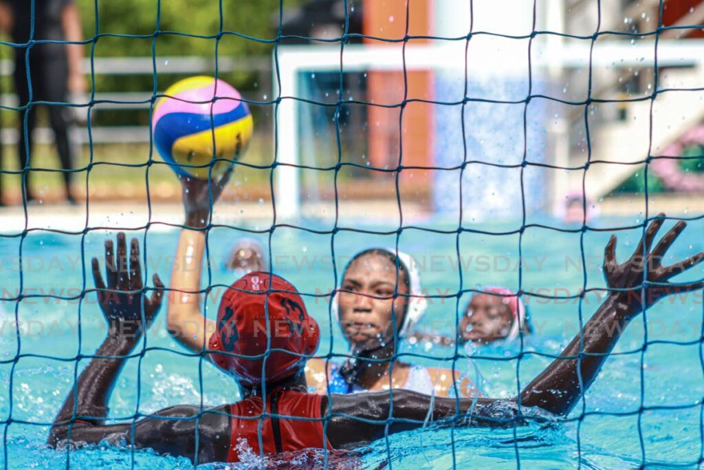 A Holy Name Convent player shoots against Bishop Anstey High School during the Republic Bank National Secondary Schools Water Polo at the National Aquatic Centre, Couva, January 25.  - Photo by Grevic Alvardo