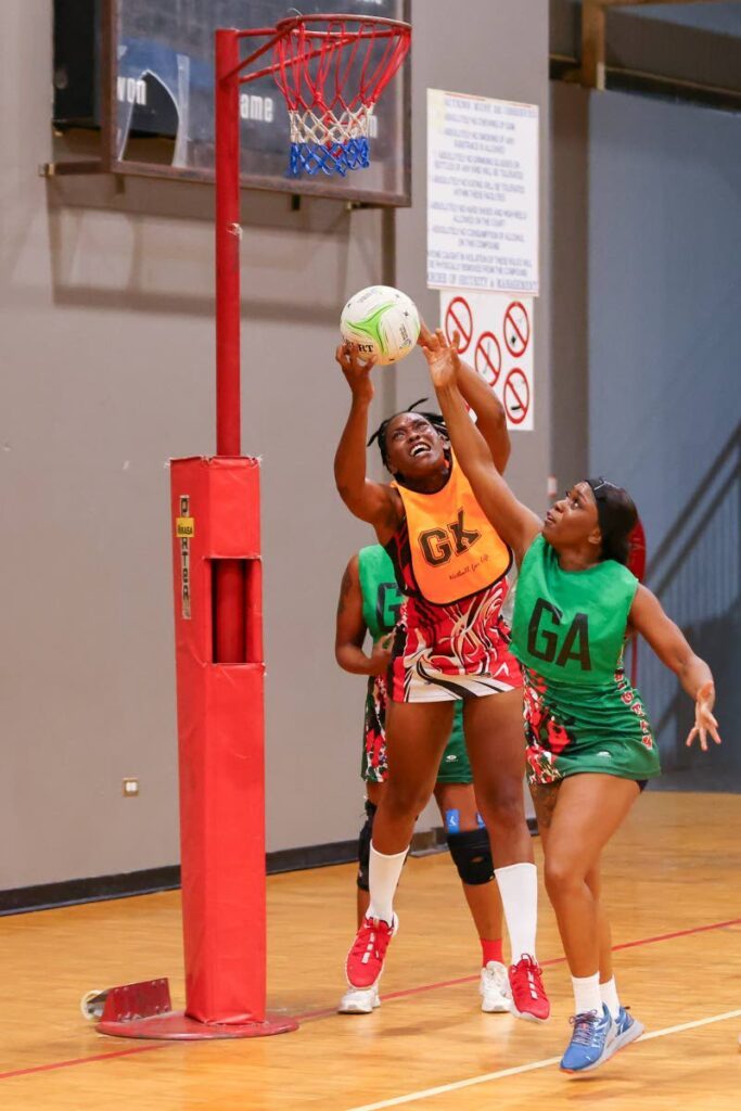  UTT goalkeeper Kielle Connelly (C) catches the rebound above Jabloteh goal attack Jeselle Navarro (R)  during the Courts All Sectors Netball Premiership league at the Eastern Regional Indoor Sports Arena on January 25, in Tacarigua.  - Photo by Daniel Prentice