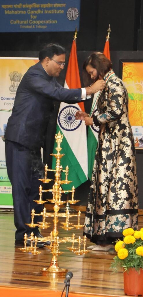 AWARDED: India's High Commissioner to TT, Dr Pradeep Rajpurohit places the Pravasi Bharatiya Samman medal on President Christine Kangaloo during a ceremony on Sunday at the Mahatma Gandhi Institute of Cultural Cooperation in Mt Hope. - Photo courtesy Indian High Commission 