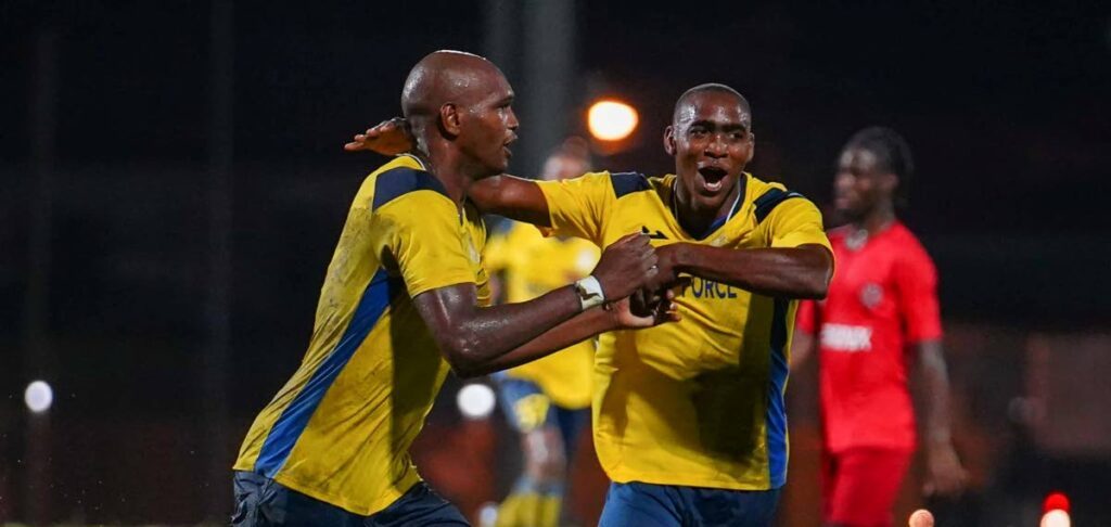 Reon Moore, right, celebrates a goal with teammate Brent Sam in 2023. - Photo courtesy TT Premier Football League