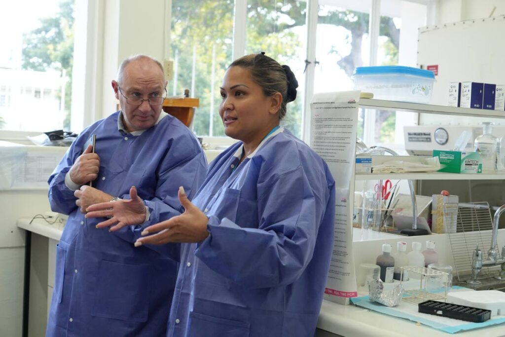 John Lee, laboratory lead for the UKHSA’s Overseas Territories programme, listens to Dr SueMin Nathaniel, acting head of Laboratory Services, Carpha at the Carpha Medical Microbiology Laboratory in Federation Park, Port of Spain, during a lab assessment visit to Trinidad between January 6 and 15. - Photo courtesy Carpha