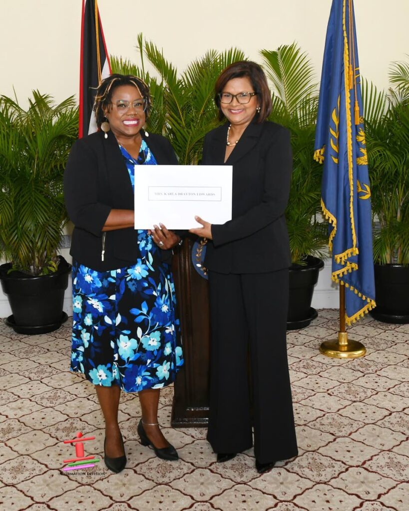 Karla Drayton Edwards stands with President Christine Kangaloo after taking her oath as a member of the EBC.- Photo courtesy Office of the President