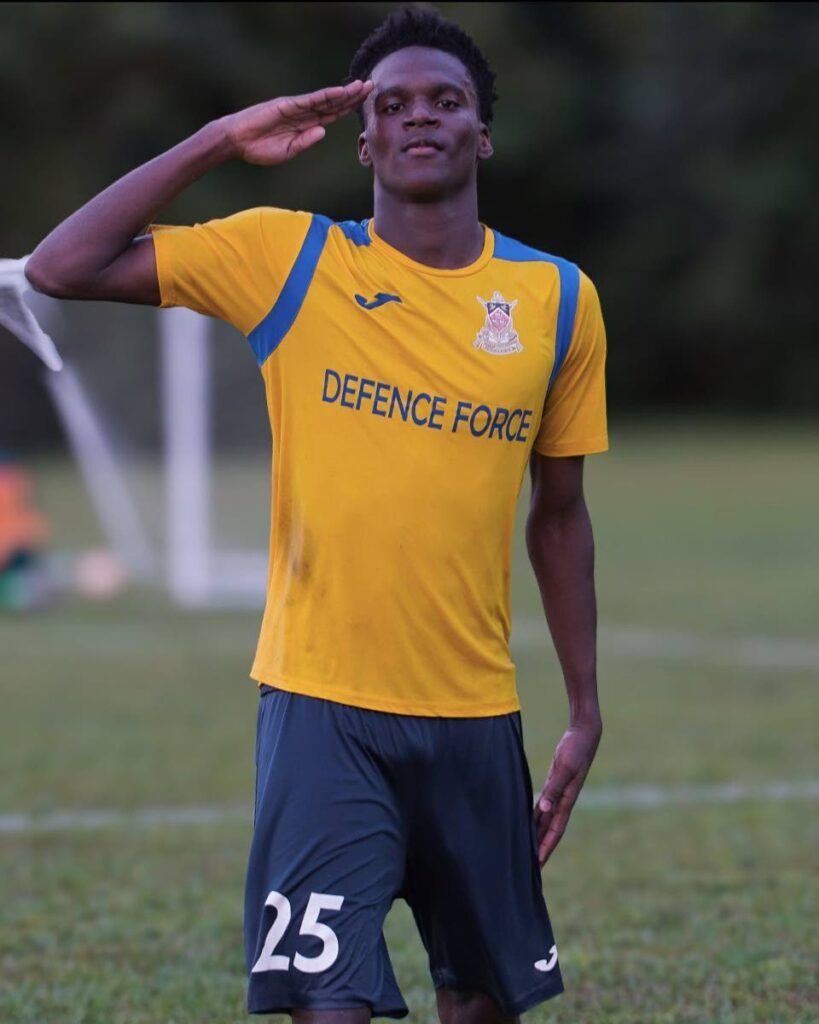 Defence Force TTPFL tier two player Philip Tinto salutes after scoring a goal in league action last month. - Photo courtesy Defence Force