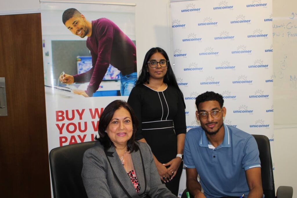 Unicomer’s director of consumer finance Sharon Maharaj, left, signs off on the Unicomer x Unipet partnership alongside Arielle Mootra, corporate projects officer (Unipet) and Mikhail Mc Comie, market diversification and expansion officer. - Photo courtesy Unicomer