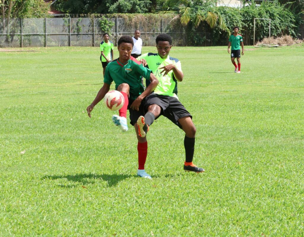 San Juan Jabloteh's Jalani Valentine (L) battles for control of the ball against an Adrenaline Football Academy player during the Republic Bank National Youth Football League match, on February 8, 2025, at the St Augustine Secondary School.  - Faith Ayoung