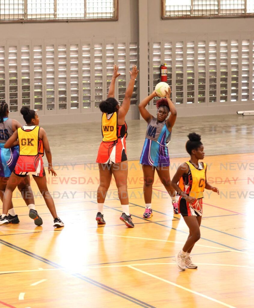 Police's Sparkle Defour looks to make a plat against UTT in the Courts All Sectors Netball League.  - Faith Ayoung/File photo