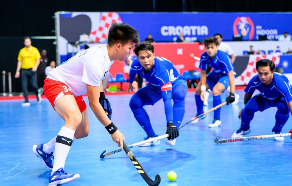 TT men's hockey player Nicholas Siu Butt is closed down by three Malaysian players during the 11th-place playoff at the FIH Indoor World Cup at th Zatika Sport Centre, Porec, Croatia on February 9. - Photo courtesy FIH  