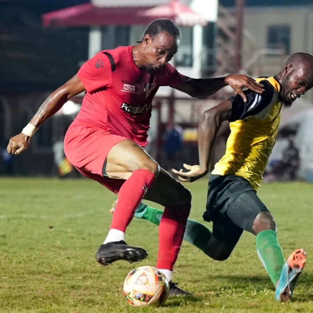 Big chop: Central FC attacker Tyrone Charles (left) sends his Point Fortin Civic marker the wrong way during a TT Premier Football League clash on January 24. - Photo courtesy TTPFL  