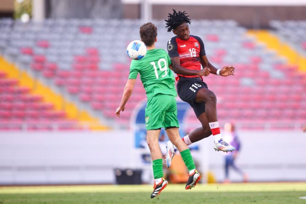 In this February 9 photo, TT footballer Josiah Kallicharan, right, battles for the ball with a player from British Virgin Islands in the Men’s Concacaf Under-17 qualifying tournament in Costa Rica.  - Photo courtesy TTFA Media