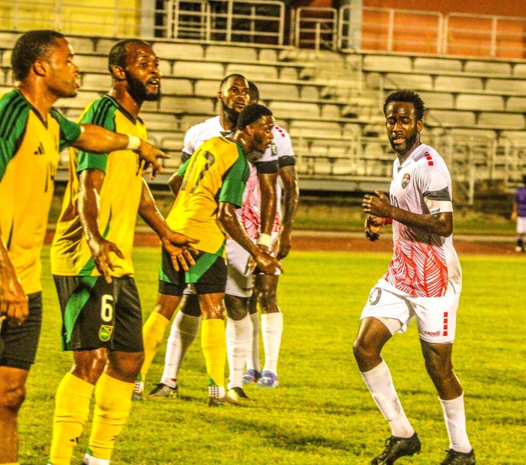 TT captain Kevin Molino, right, in action during a friendly on February 6 against Jamaica, in Montego Bay, Jamaica. - Photo courtesy TTFA Media