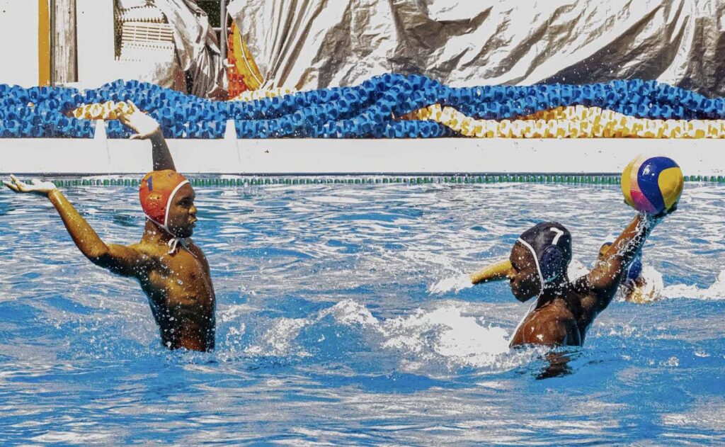 St Mary's College's Evan Gillard-Bruce (right) takes a shot at goal as Fatima College goalkeeper Josiah Cumberbatch makes himself big during their clash in the open category of the Secondary Schools Water Polo League at the National Aquatic Centre, Couva on February 8, 2025. - Photo courtesy Cindy-Lou Valentine.  