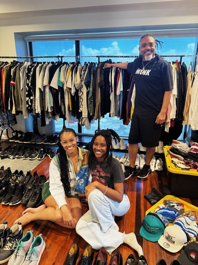 Machel Montano and the owners of 2nd Closet, Aliyah Clarke, left, and Kaleen Sanois, right, among the clothing, shoes, caps and accessories to be curated for the Pop Up Vintage Shop with Machel Montano. - 