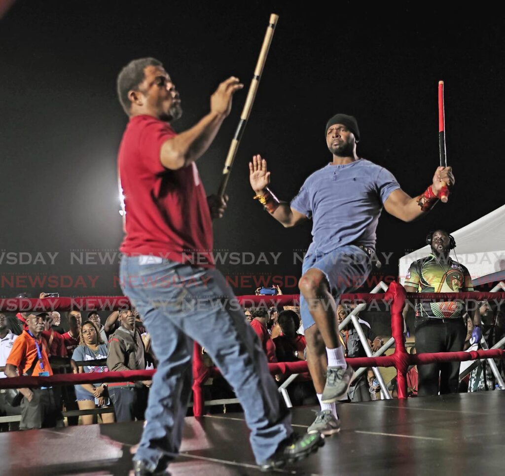 Reigning sticking champion Oniel Odle battles with Learie Licorish in the preliminary round will defend his title in the finals of the NCC National Stickfighting competition on February 26 at Skinner Park, San Fernando. Here, Odle battles with Learie Licorish in the preliminary round at the Moruga Multi-Purpose Youth and Sport Facility. - Photo by LIncoln Holder 