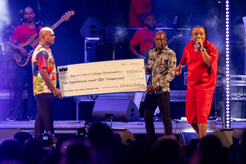 Machel Montano, right, shares the stage with president of the QRC Old Boys Association Kenrick Harrinauth, left, and principal David Simon, centre, after presenting them with a cheque for $250,000. - Photos by Daniel Prentice