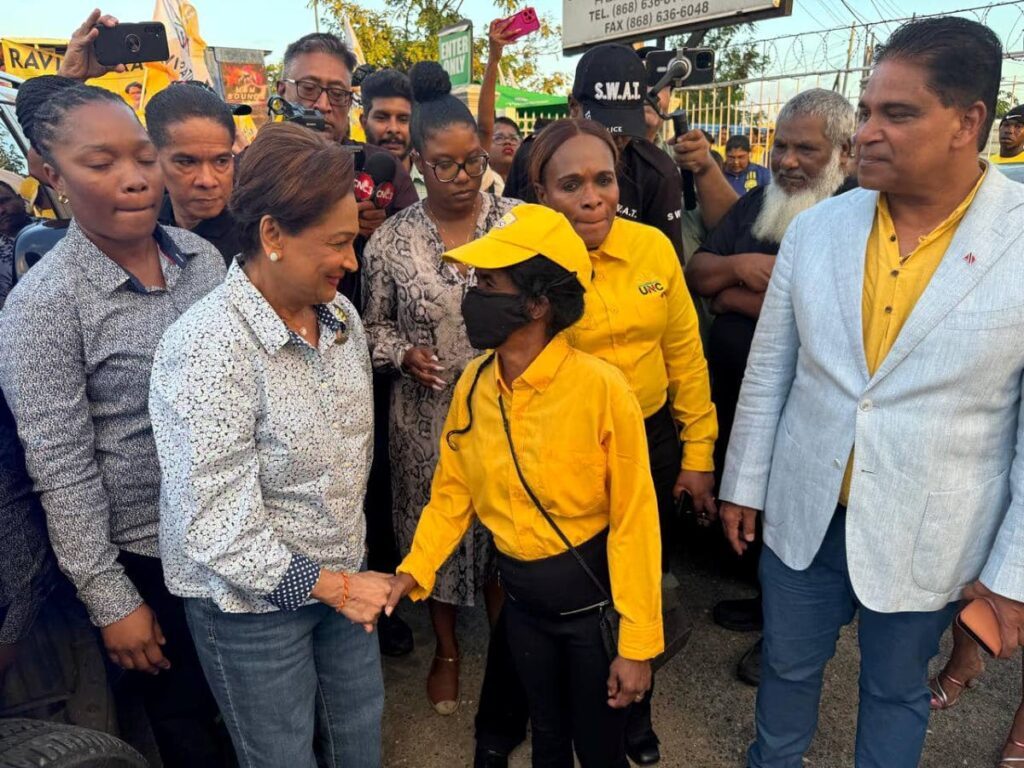 Opposition Leader Kamla Persad-Bissessar greets supporters at the United National Congress headquarters in Chaguanas on February 17.  - Photo courtesy UNC 