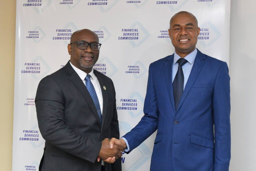 SECURE HANDSHAKE: SEC chief executive Kester Guy, left, is greeted by Jamaica's Financial Services Commission head Lt. Col Keron Burrell, during Guy's recent courtesy call on Burrell  in Jamaica. - Photo courtesy the SEC  