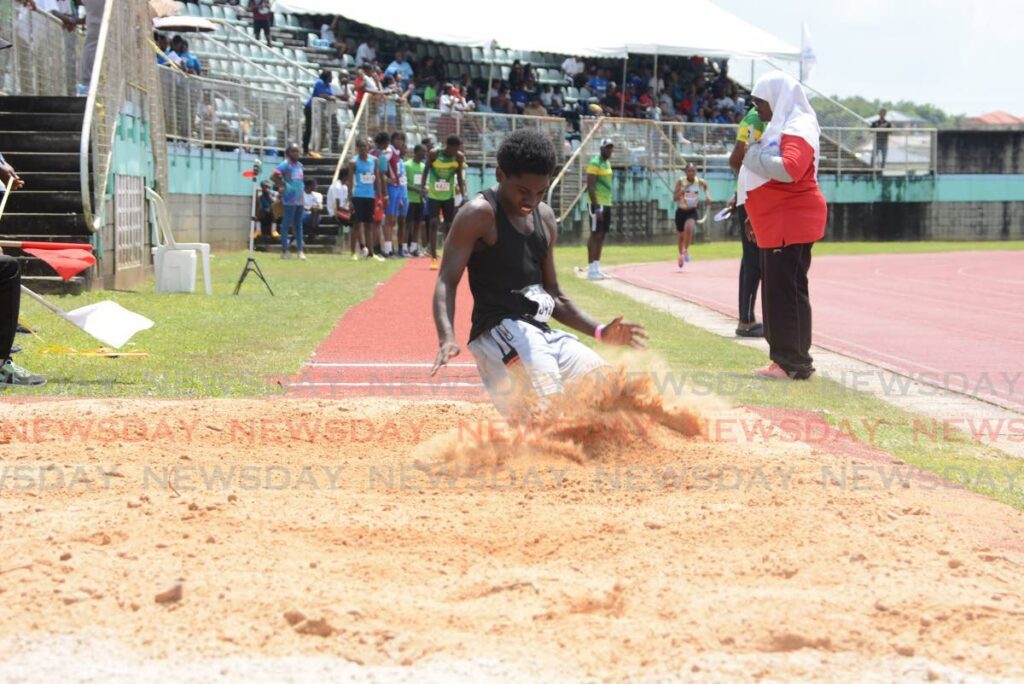 Cowen Hamilton Secondary School’s Mark Weston completes his jump during the boys’ 17+ long jump during the Secondary Schools Track and Field South Central Regional Championships, on February 18, at the Manny Ramjohn Stadium, Marabella.  - Photos by Innis Francis