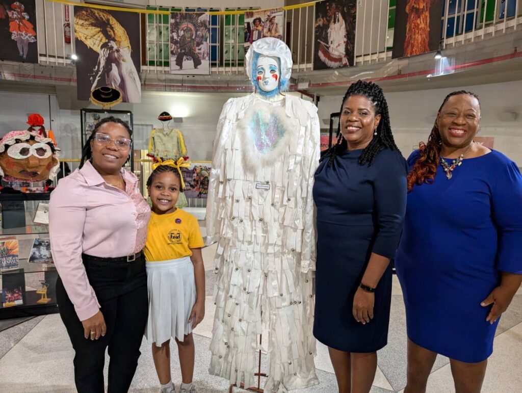 Nathania Monsegue, left,  and daughter Xiomara,  Nalis executive director Paula Greene and director Heritage Library Division Jasmin Simmons at the launch of the Nalis Carnival exhibition. - 