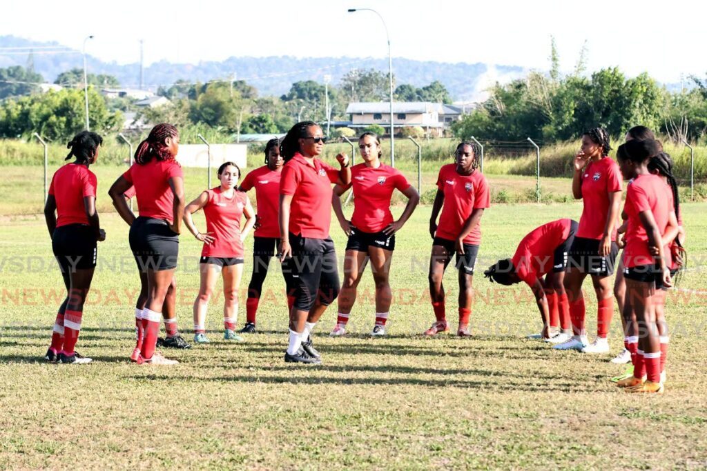 PEP TALK: TT Under-20 women's coach Dernelle Mascall (C) speaks with players during a team trainin session, on February 18, at the Ato Boldon Stadium, Couva.  - Photos by Lincoln Holder 