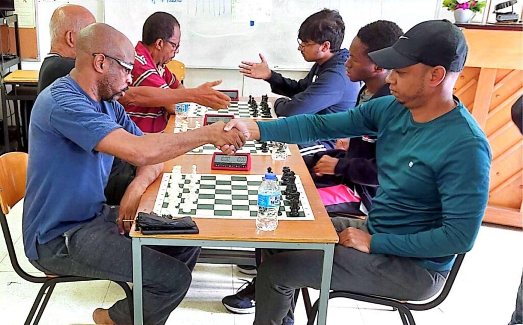 FIDE Masters Mario Merritt (L) and Marcus Joseph (R) shake hands at the start of play in a recent showdown. Photo courtesy Paladins Chess Club  - 