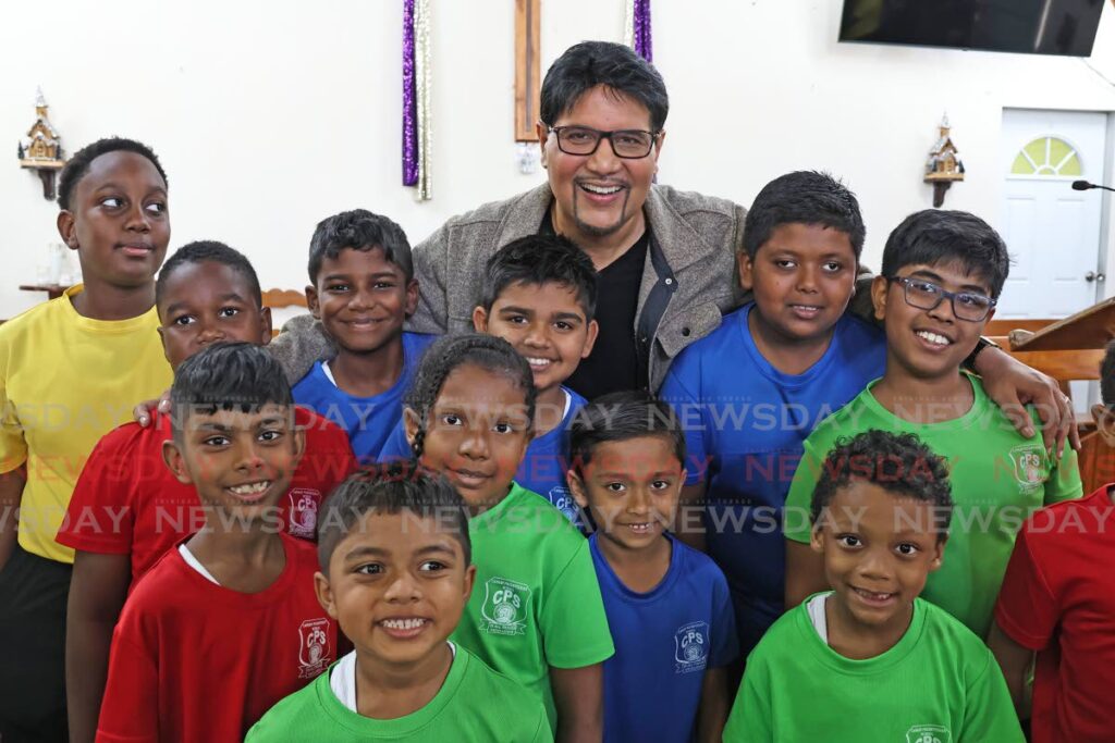 High Court Judge Frank Seepersad with students of the Canaan Presbyetrian School following his feature address during the school's week of activities against anti-bullying at the Canaan Presbyterian Church, Duncan Village, San Fernando, on February 21. - Photo by Lincoln Holder 