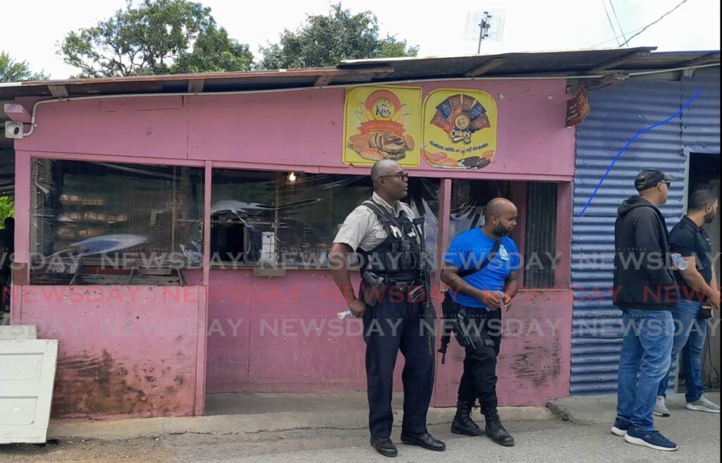 Police prepare to interview residents outside the parlour on La Retreat Extension Road where Anicia James, her common-law husband Mitchell Francois and her brother Anselm James were murdered on February 22. FILE PHOTO/GREGORY MCBURNIE - 